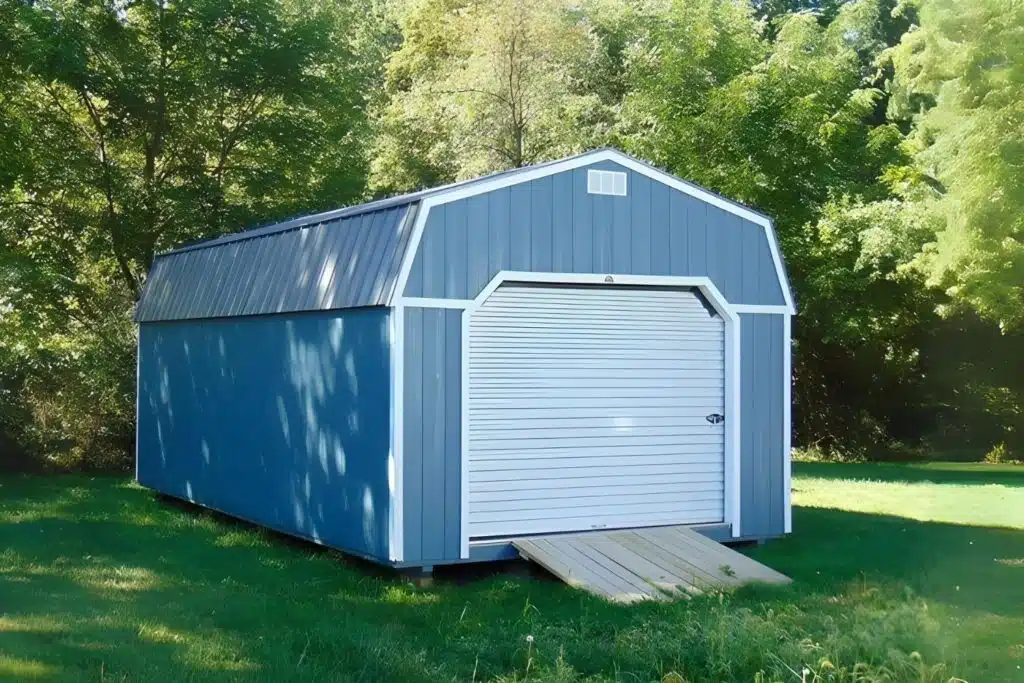Blue and white pre fab garage in fremont IN with ramp, set in grassy field