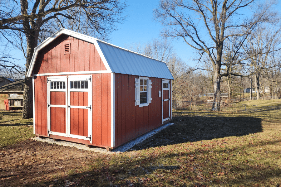 Red mini barn with swing doors.