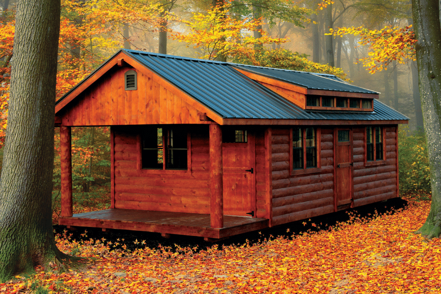 Cabin in forest with fall leaves. Blue Gray roof.