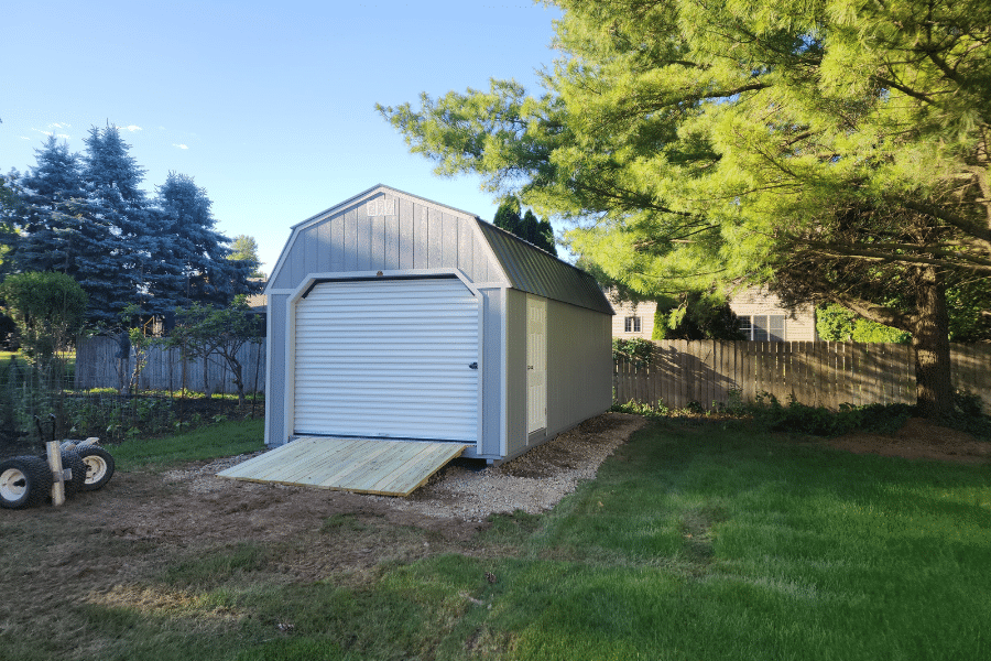 Small detached garage white door.