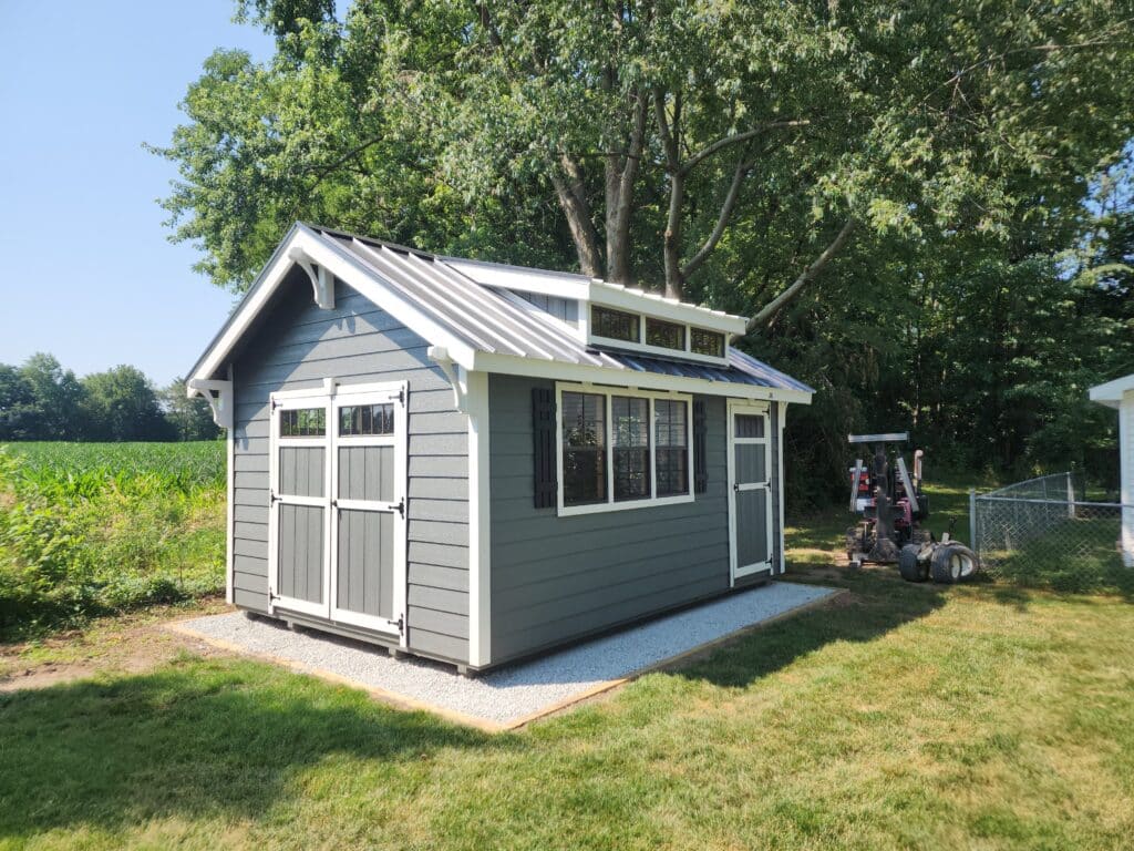 Gray shed with swing doors.