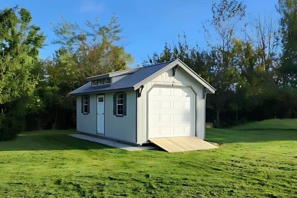 Prebuilt garage with wooden ramp in lawn